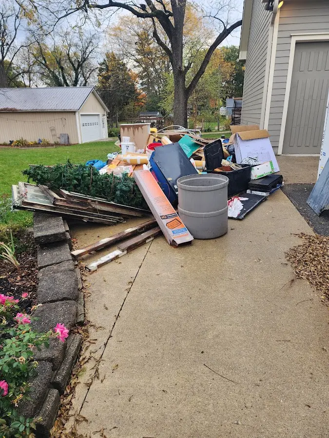 Dumpster being loaded with debris for Roofing Dumpster Rental in Hainesville